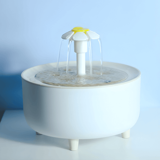 White pet water fountain on a light blue background