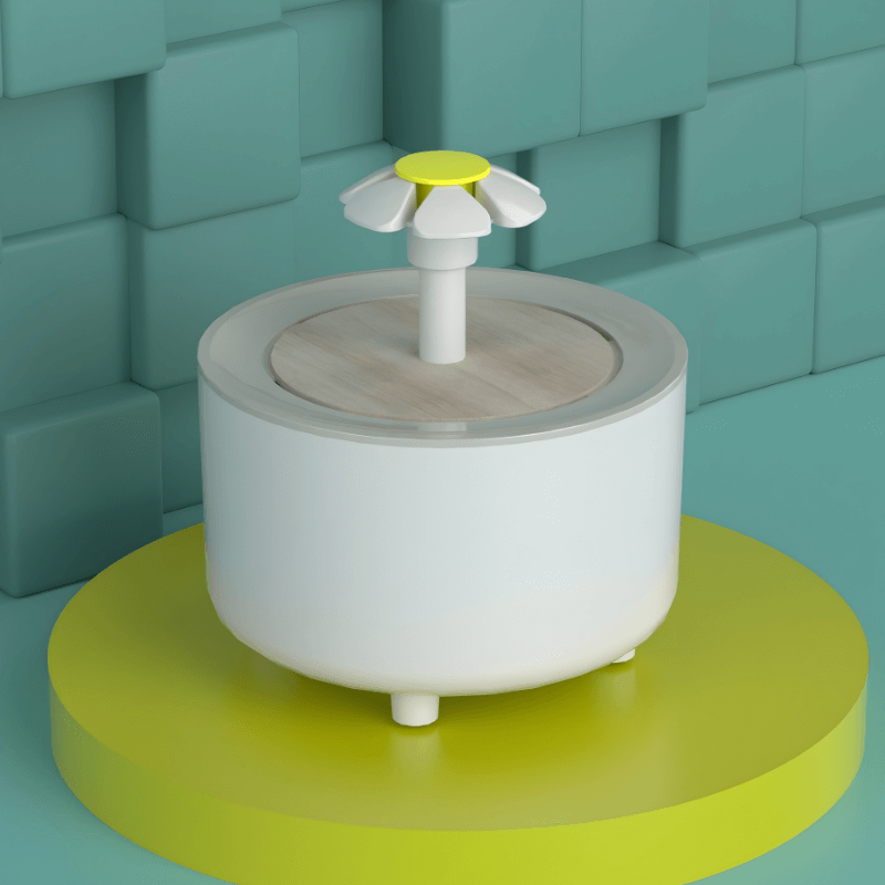 White and gray container with a yellow top on a green platform against a teal brick wall.