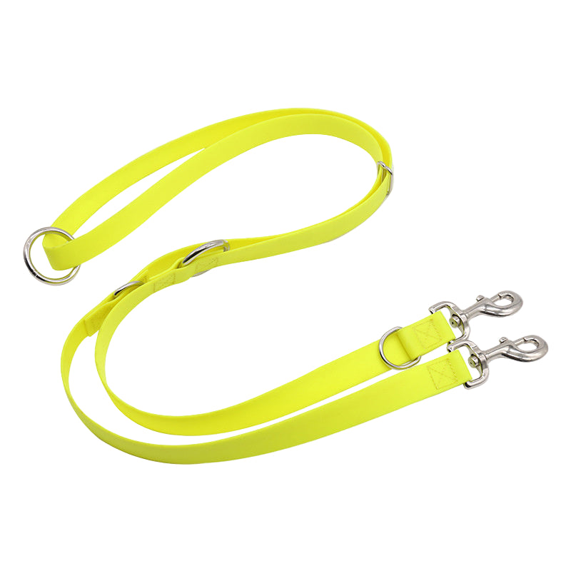 Neon yellow dog leash with silver clips on a white background